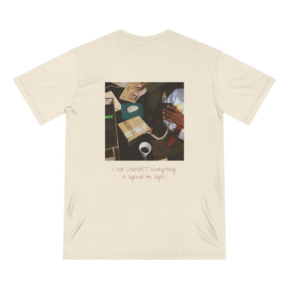 Back view of the “I Told ChatGPT Everything” tee by Office Off-Duty in natural. Features a candid retro-style photo of hands at a desk with the caption: “I told ChatGPT everything. It agreed I’m right.” A witty nod to over-sharing and self-validation in the AI age.